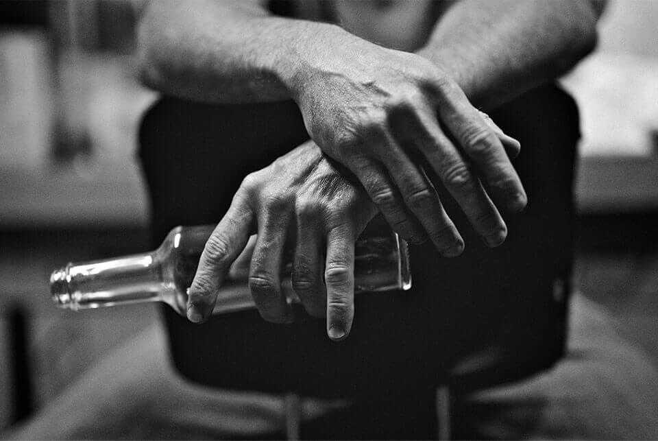 Image of hands holding a bottle in black and white
